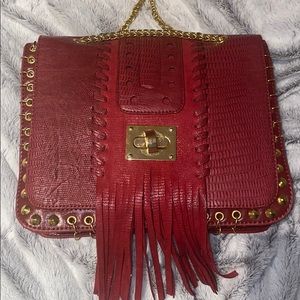 Red faux reptile skin leather bag with fringe